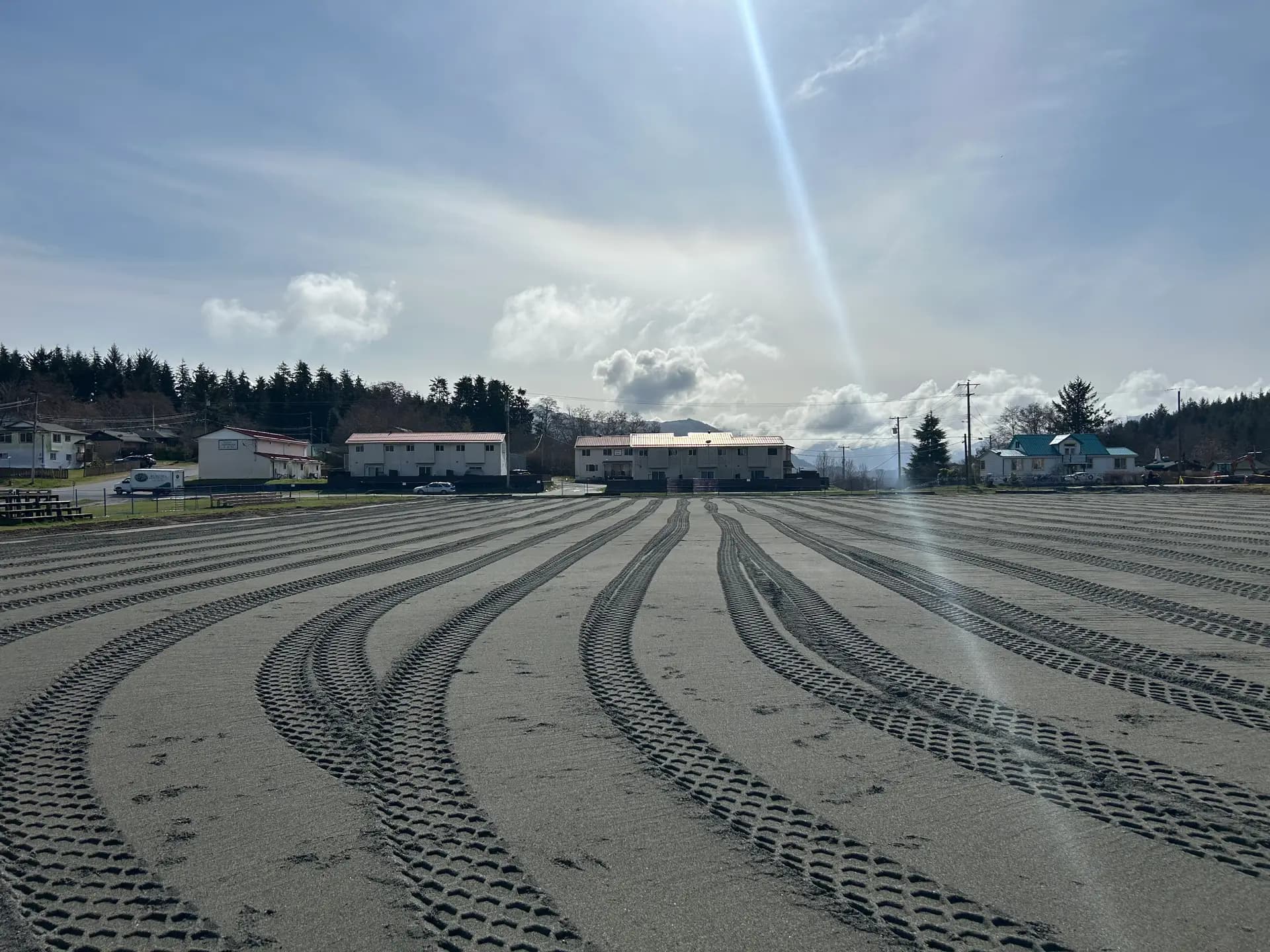 Compacted granular base with roller tracks on a building pad
