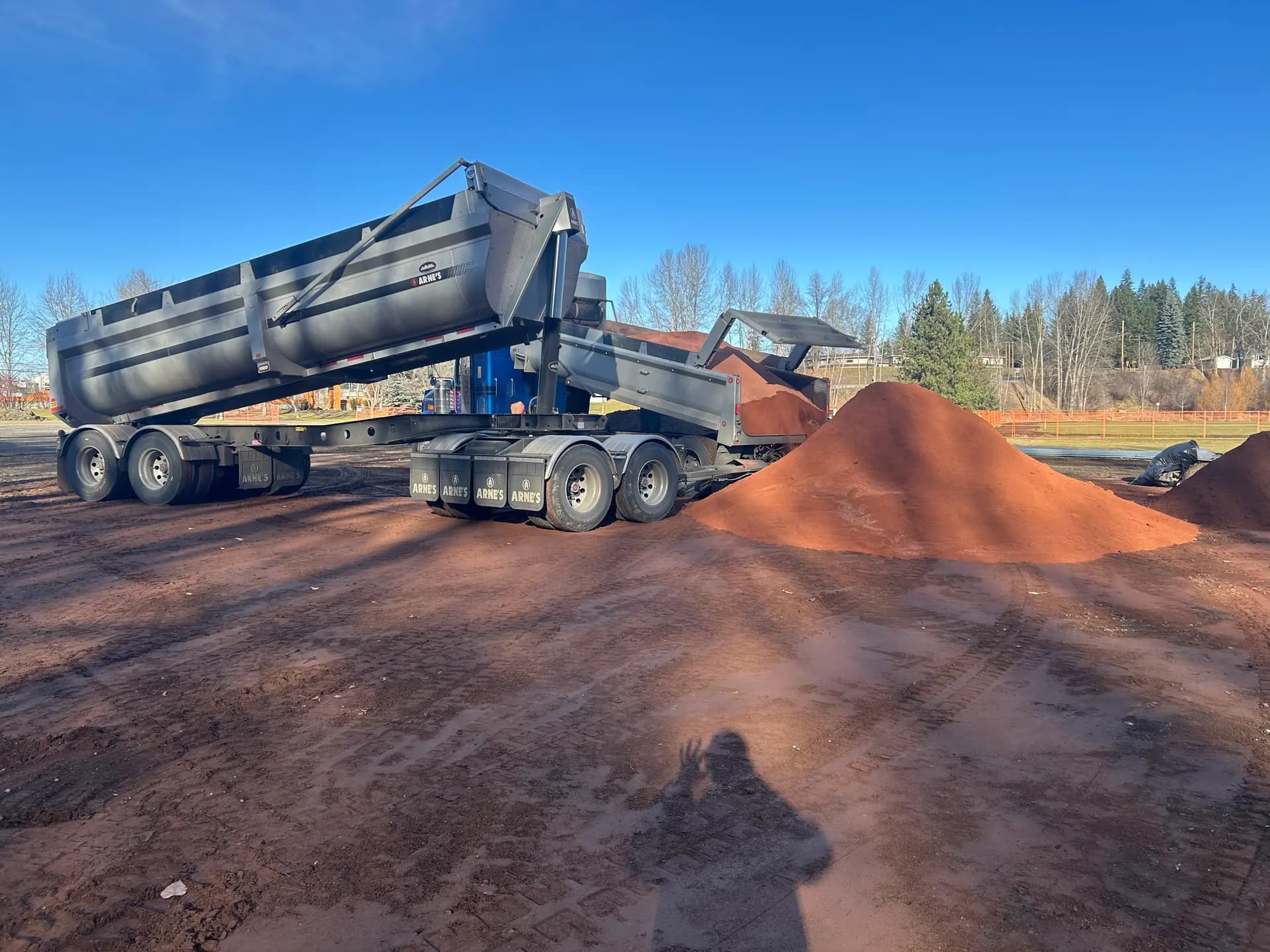 End dump trailer delivering red infield shale material