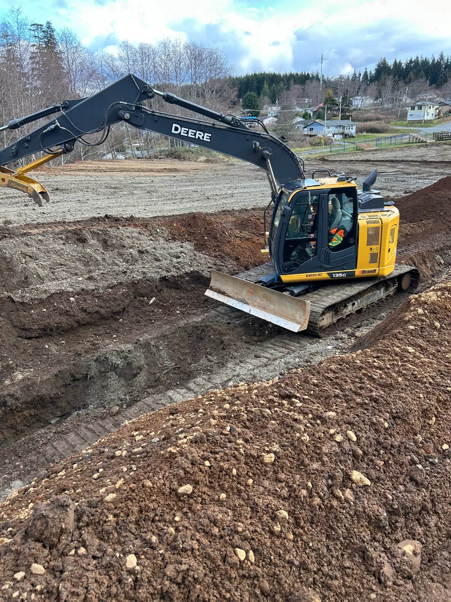 Excavator cutting grade on a coastal site development
