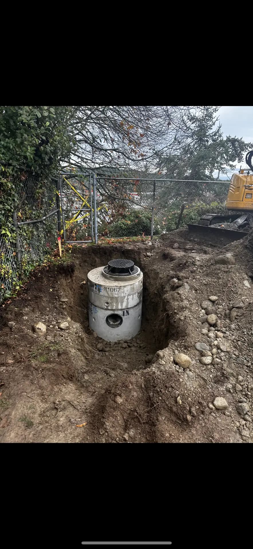 Precast manhole set and backfilled during a sewer main replacement
