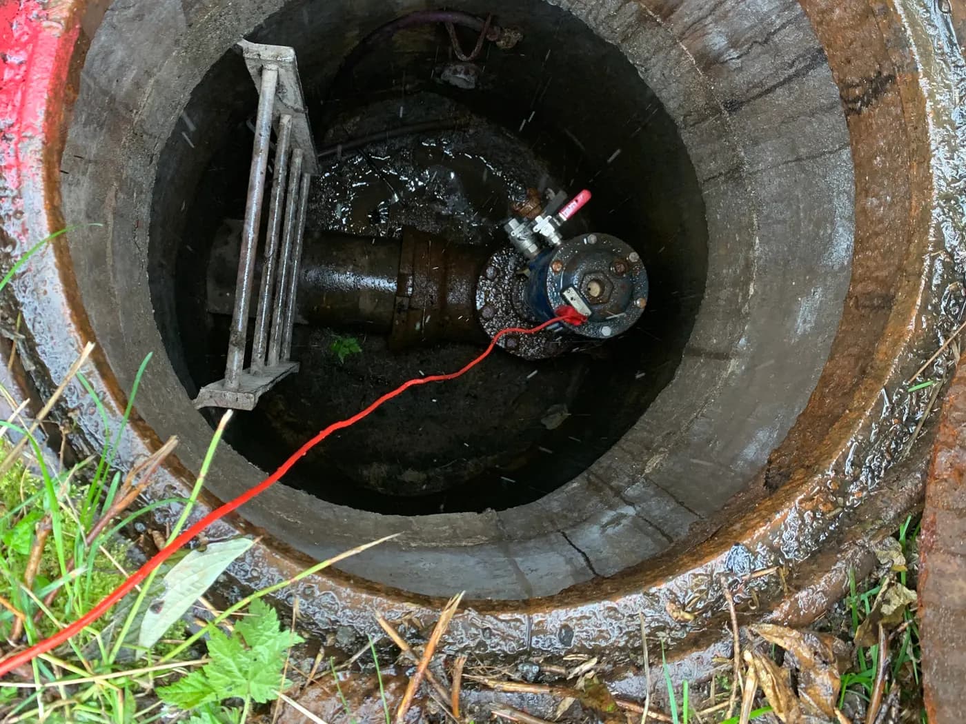 Inside a manhole chamber with a valve assembly during utility maintenance work