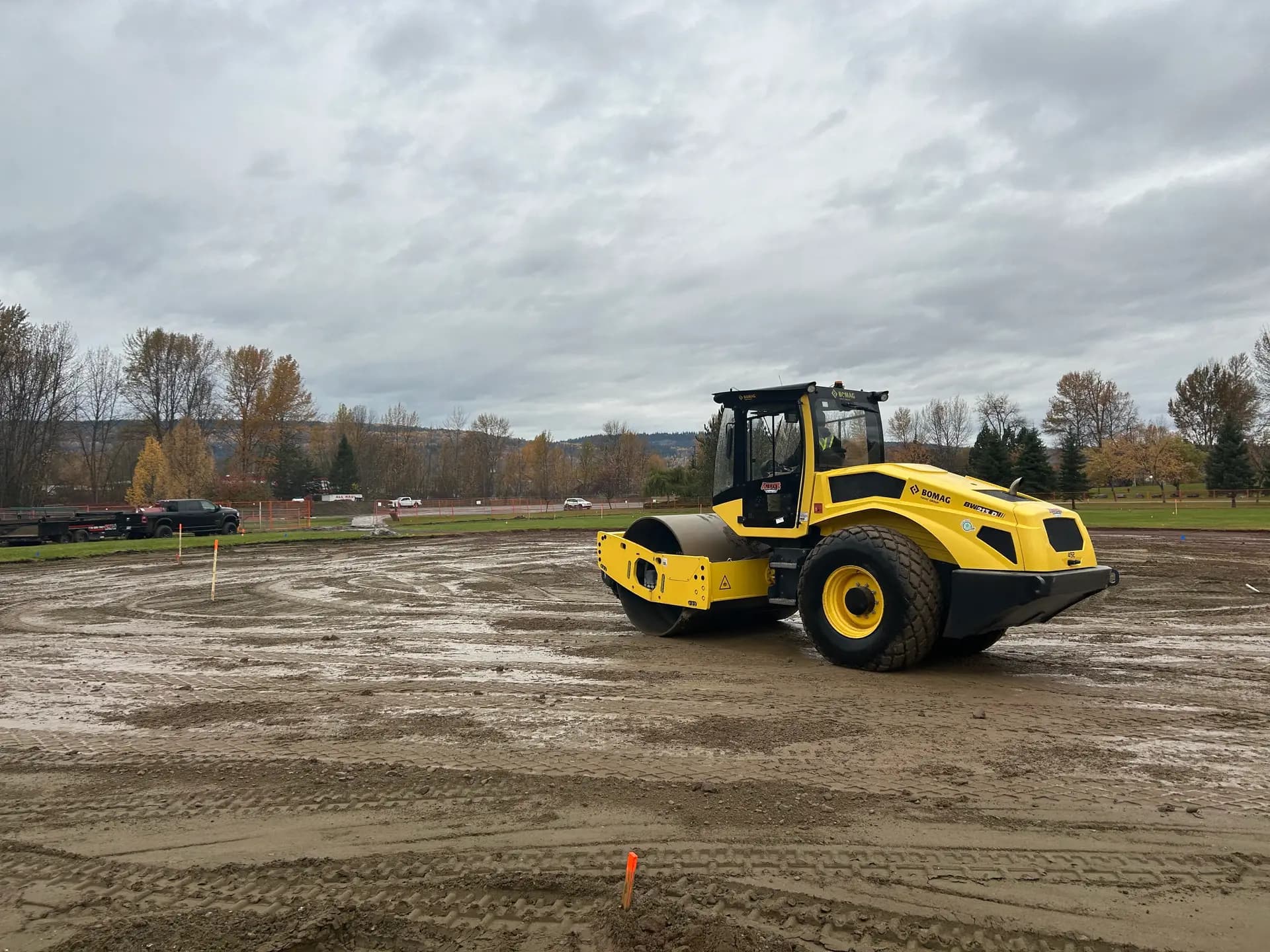 Smooth drum packer compacting subgrade for a new sports field