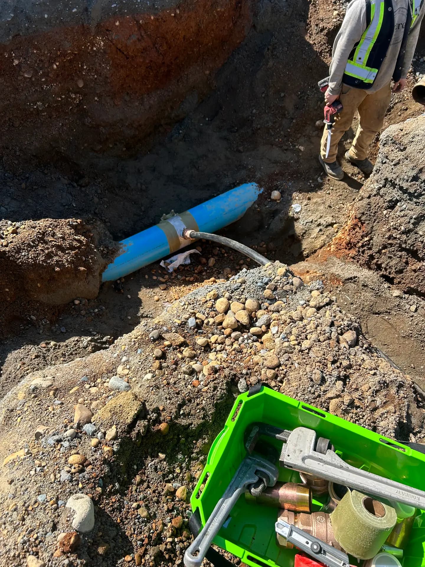 New blue HDPE water service pipe installed in a bedded trench